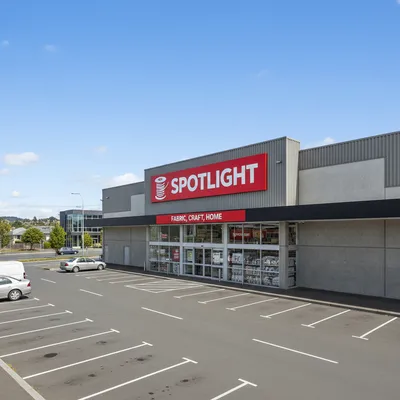 The entrance and exterior of the Spotlight Dunedin store, a large retail building located on Vogel Street in Dunedin, New Zealand, with clear branding visible.